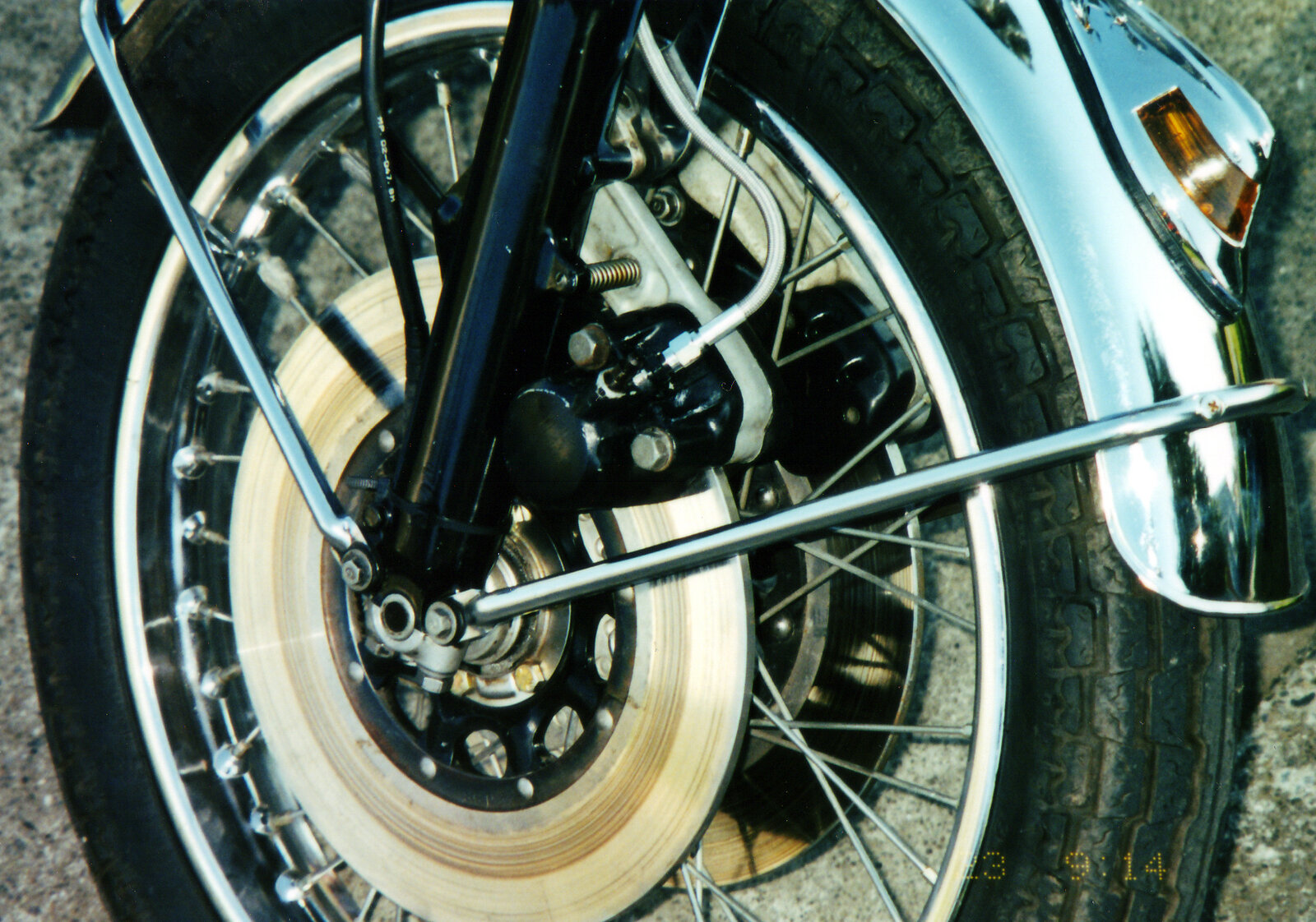 Front wheel with spoked rim, disc brake, caliper and brake line