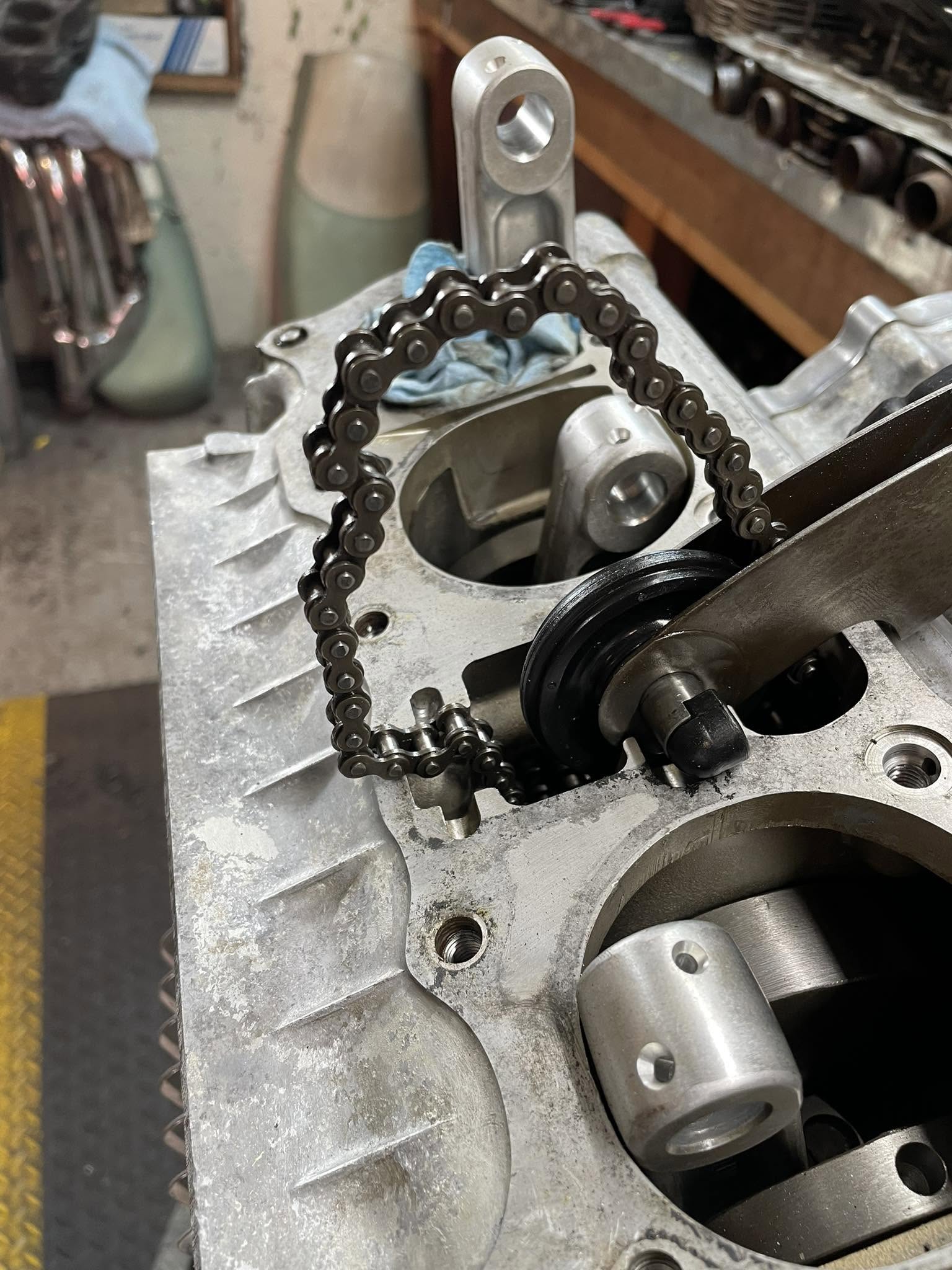 Cylinder head with the cam chain and tensioner being checked