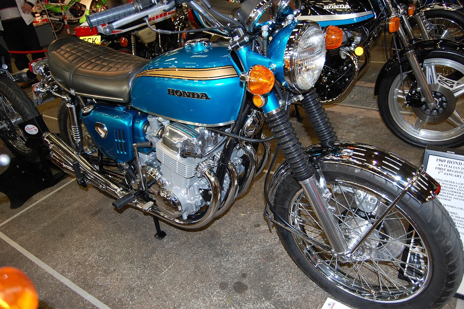Blue-green early Honda CB750 on display with other classic Hondas