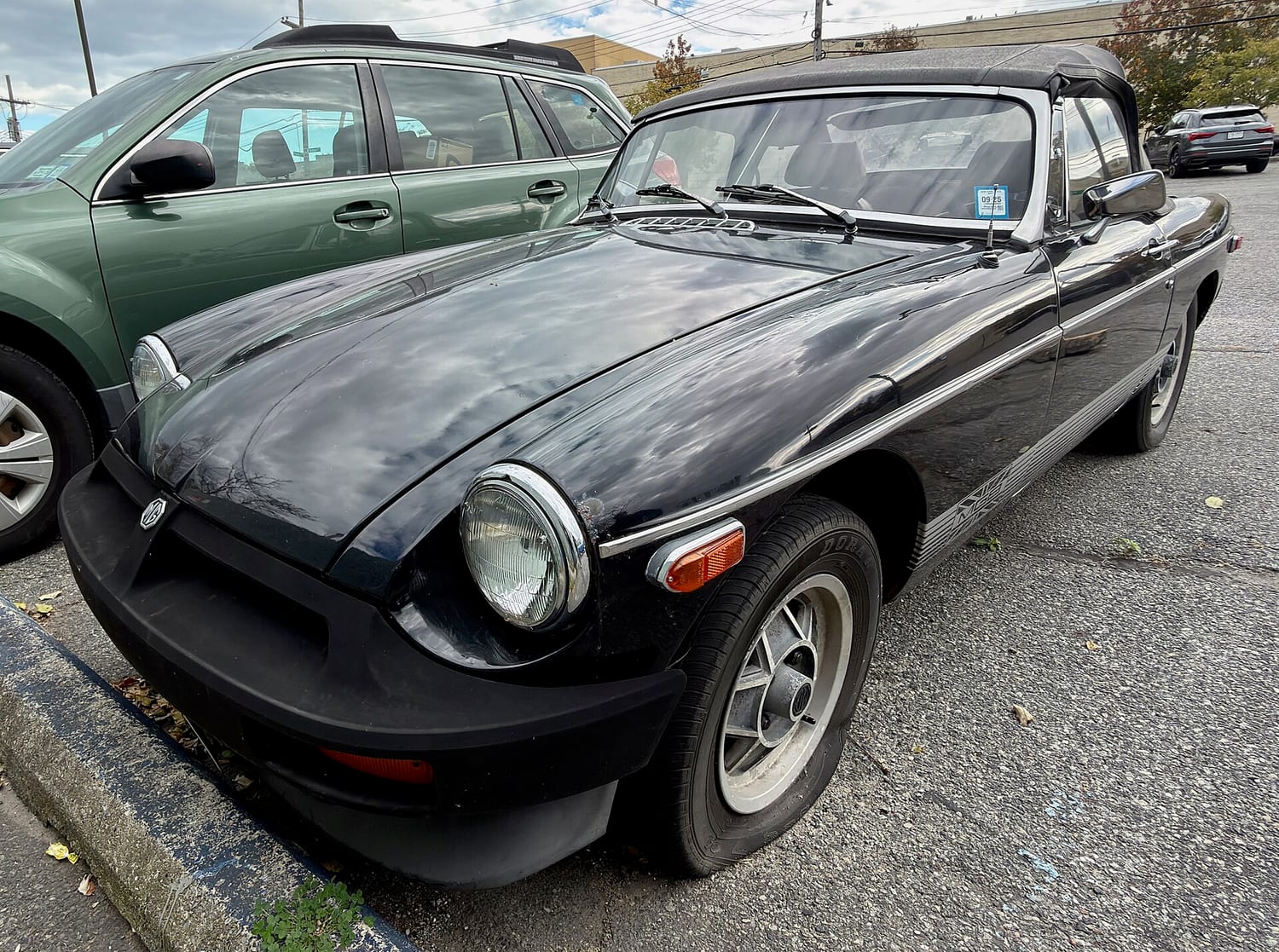 Black 1980 MGB roadster parked on a street