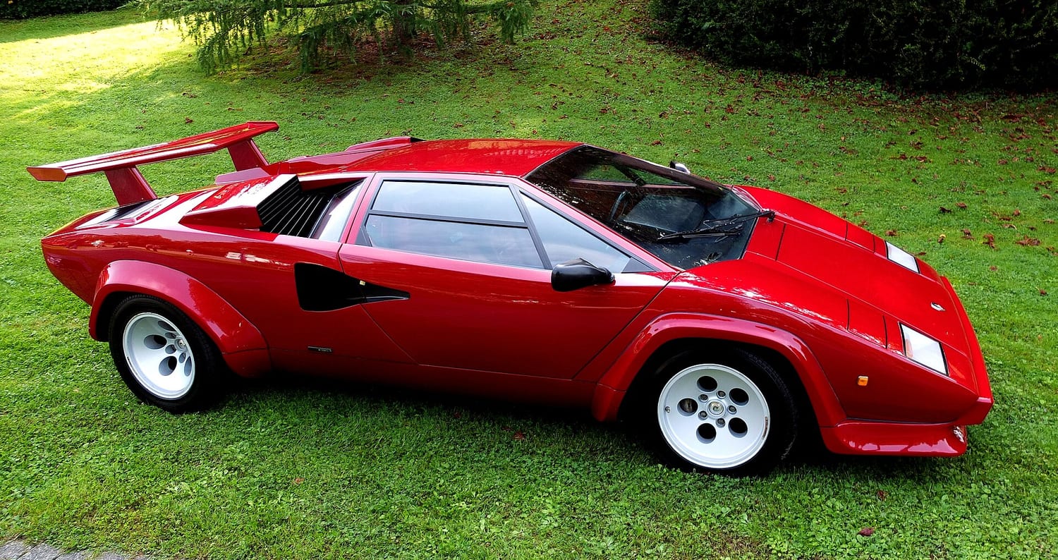 Red Lamborghini Countach LP 5000 S from 1983 on grass