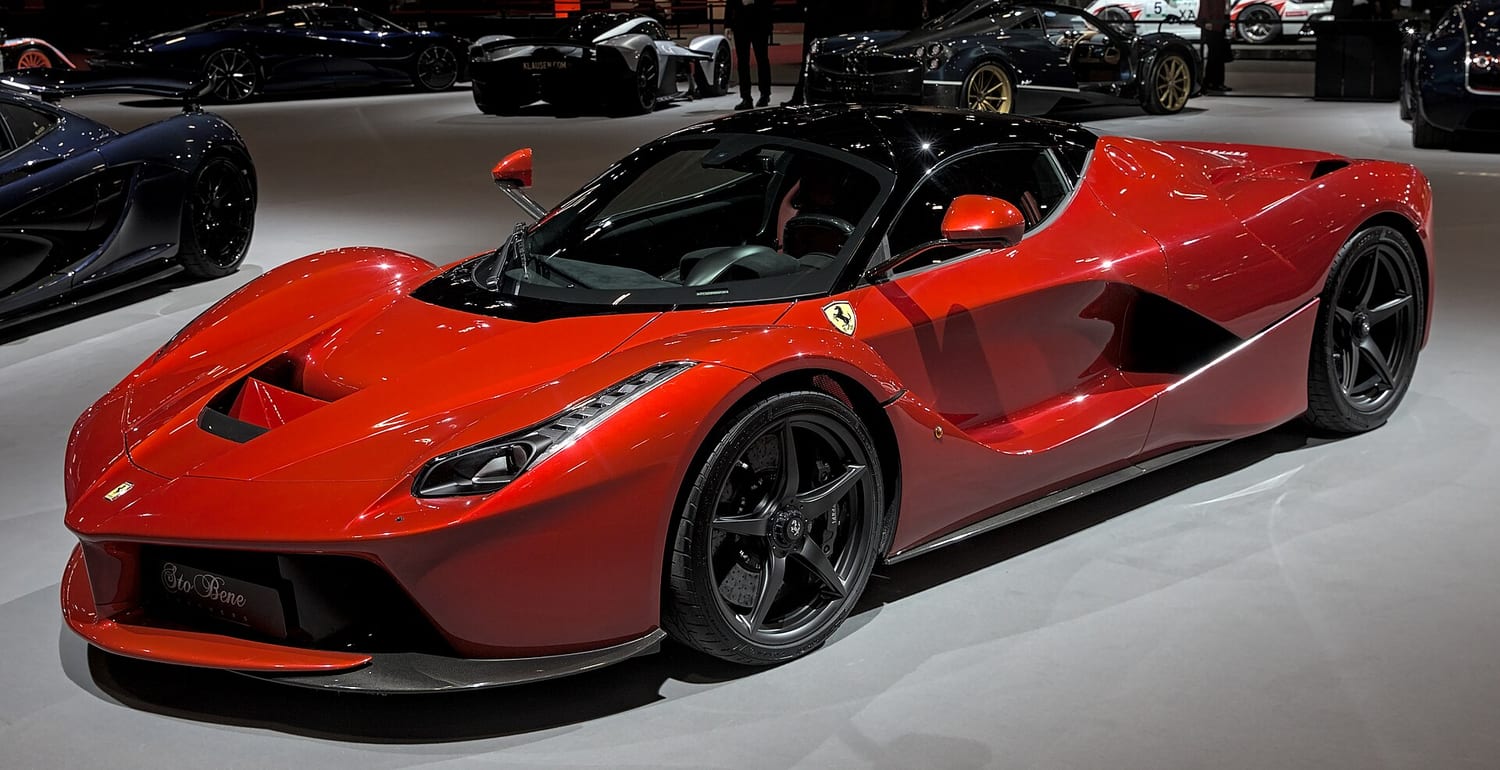 Red Ferrari LaFerrari with its roof removed on a display stand