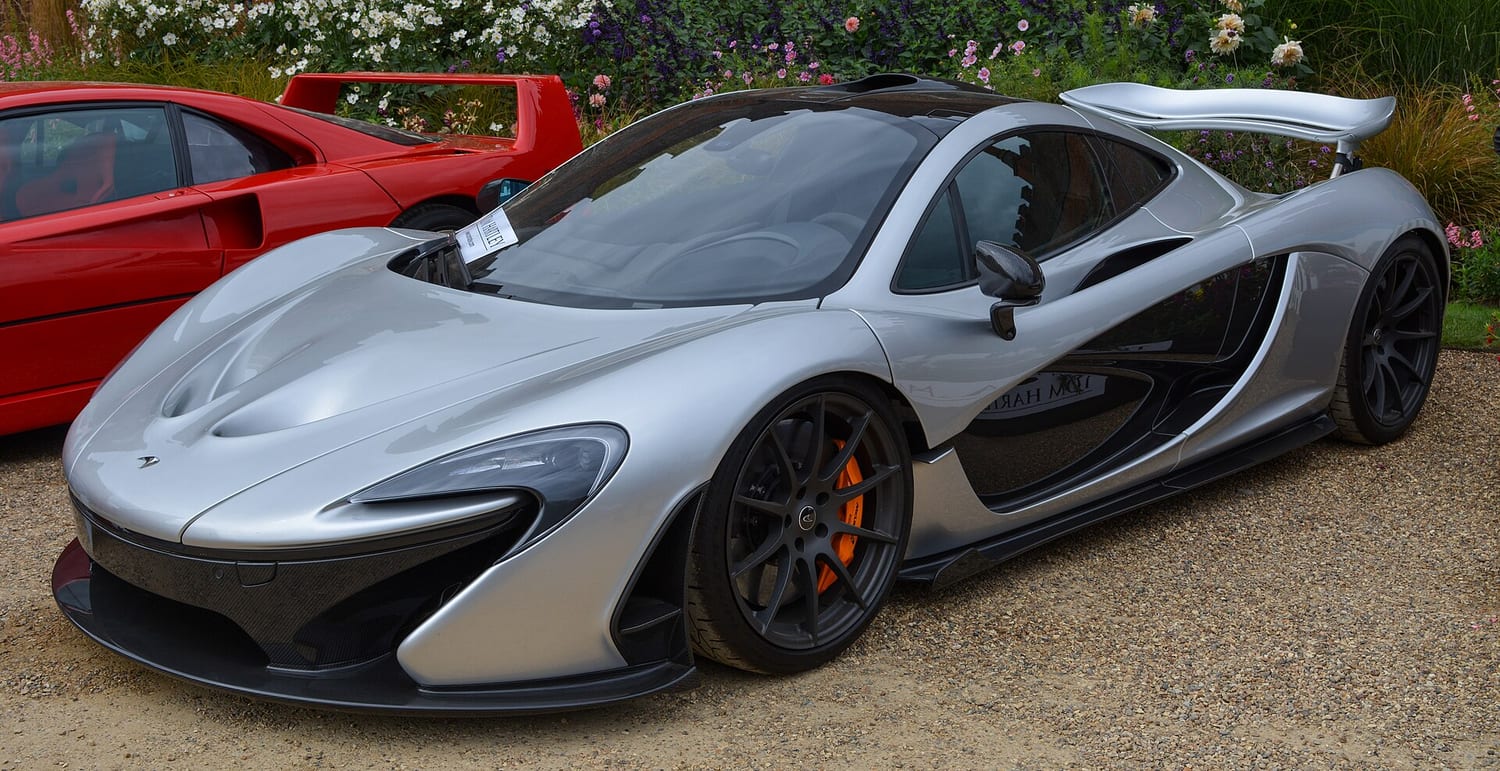 Silver McLaren P1 seen from the front at a concours