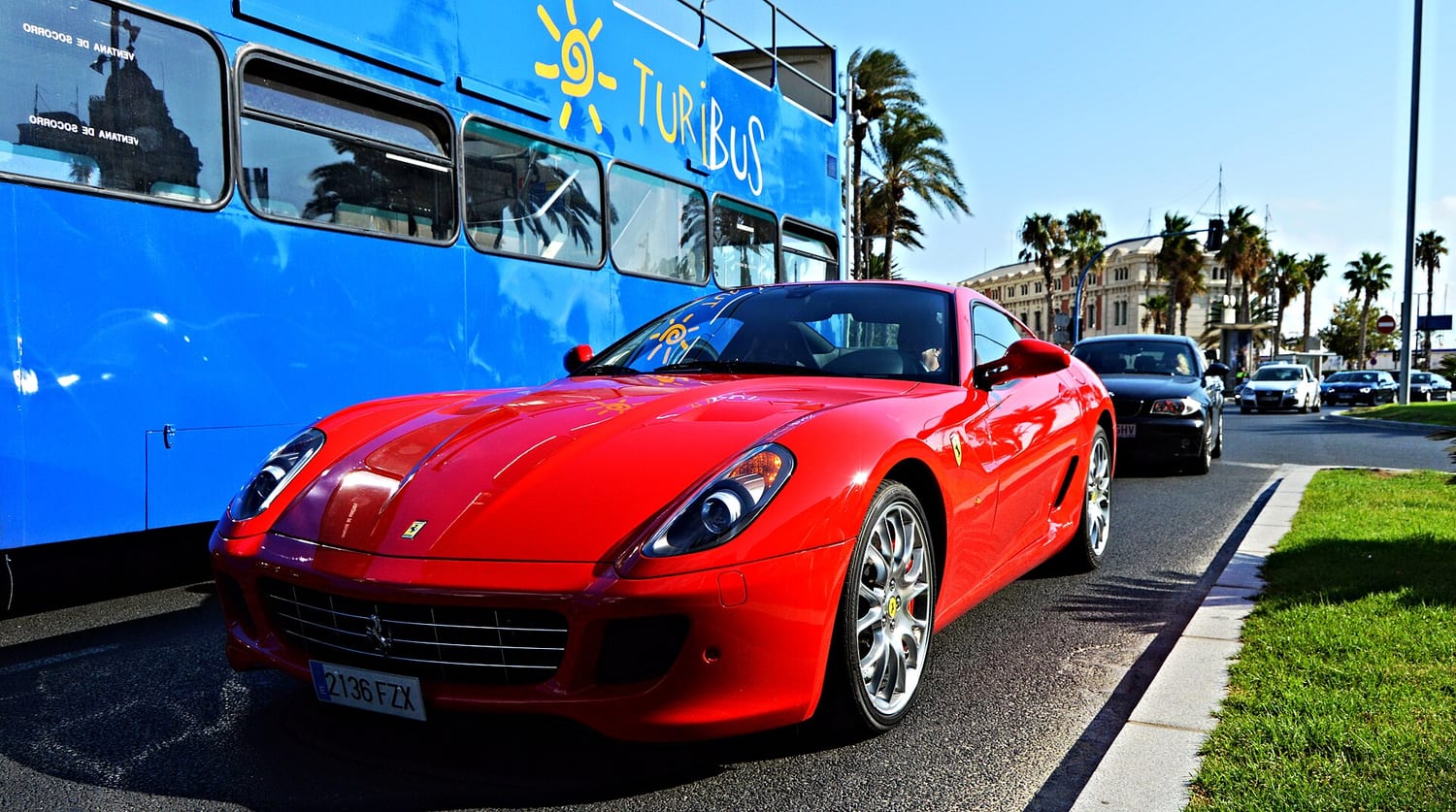 Red Ferrari 599 GTB Fiorano on a seaside road